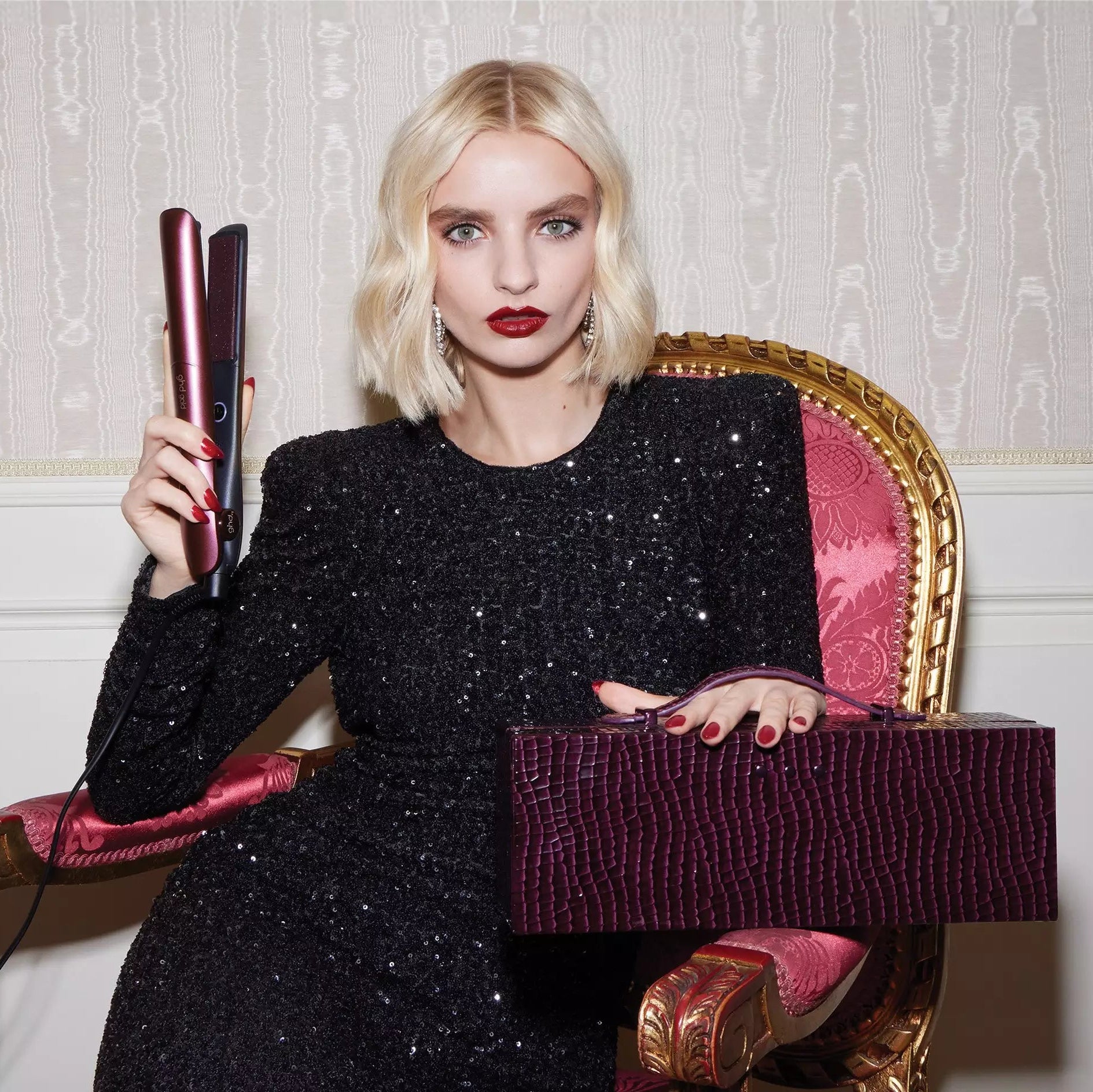 Model holding ghd Cherry Chic Gold Hair Straightener Gift Set 