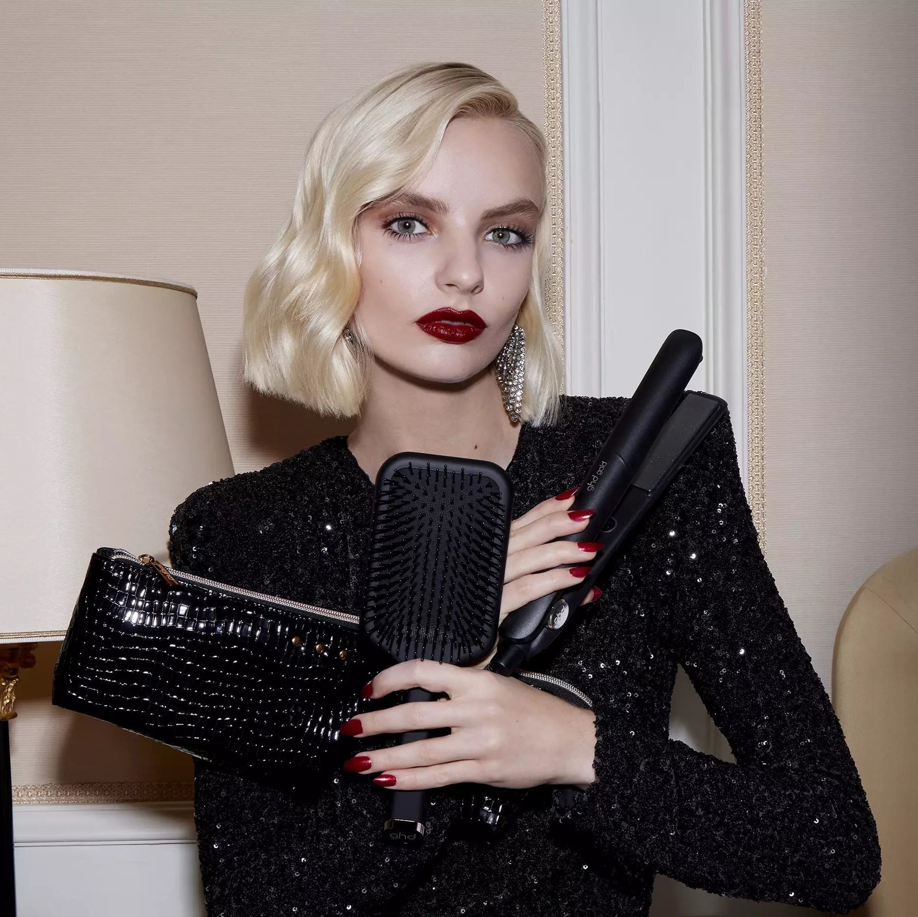Blonde model holding ghd Gold Hair Straightener Gift Set 