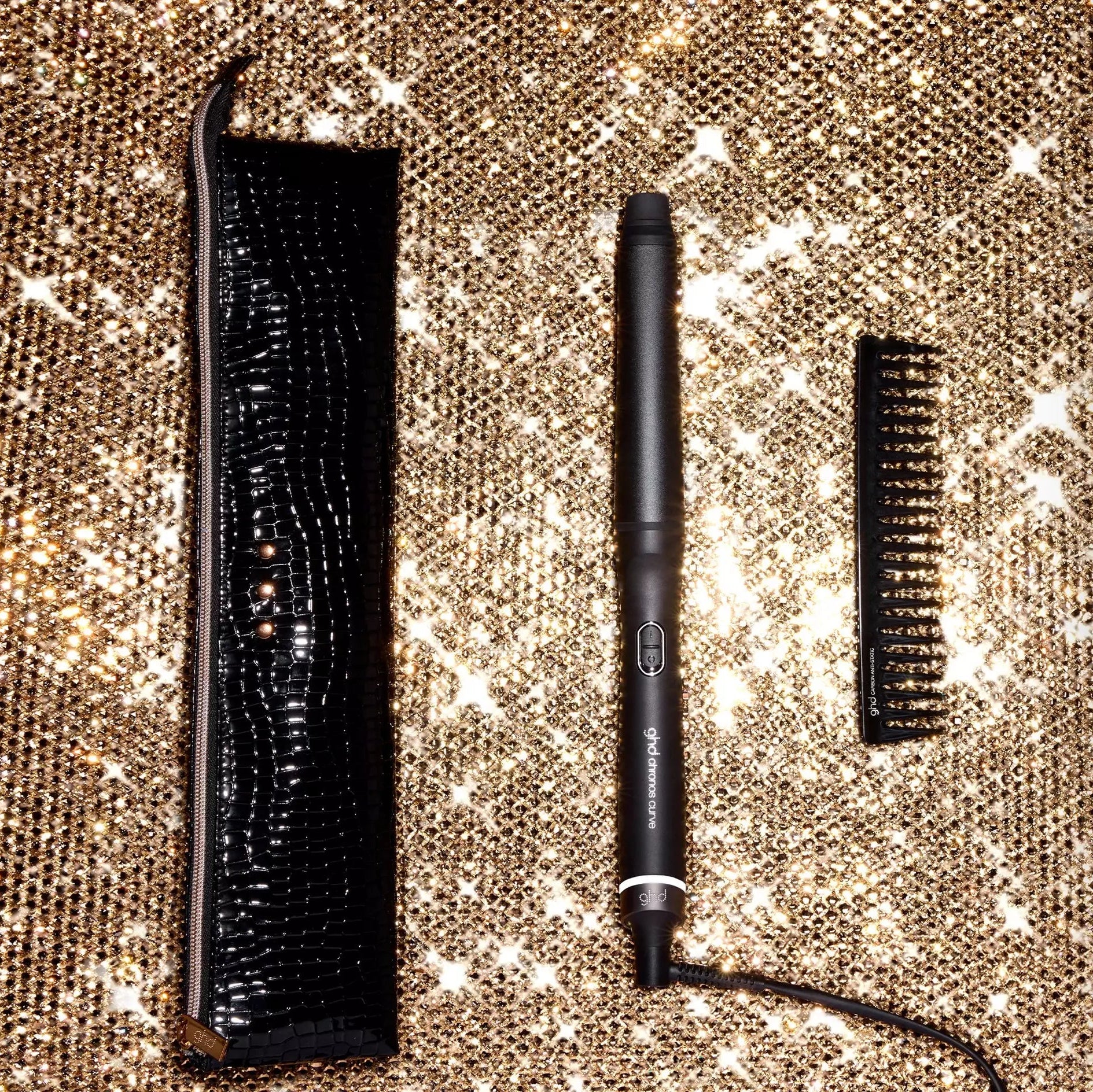 ghd Chronos Curve Conical Wand Christmas Gift Set opened on a gold sparkly background