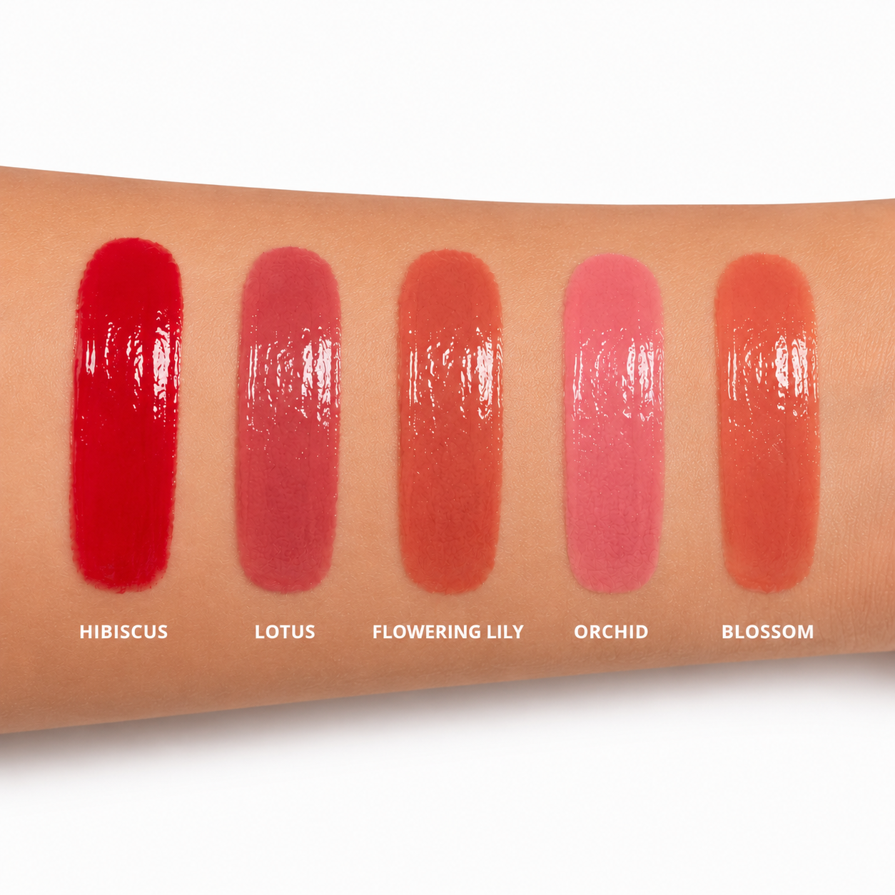 Dominic Paul Lip Glaze swatches on model's arm
