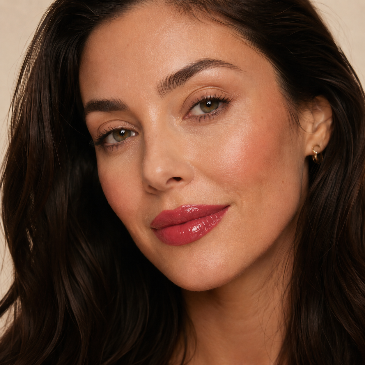 Dark haired model wearing Dominic Paul Lip Glaze Lotus