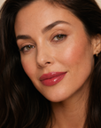 Dark haired model wearing Dominic Paul Lip Glaze Lotus