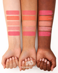 Colour swatches on model's arms of Dominic Paul Powder Blush