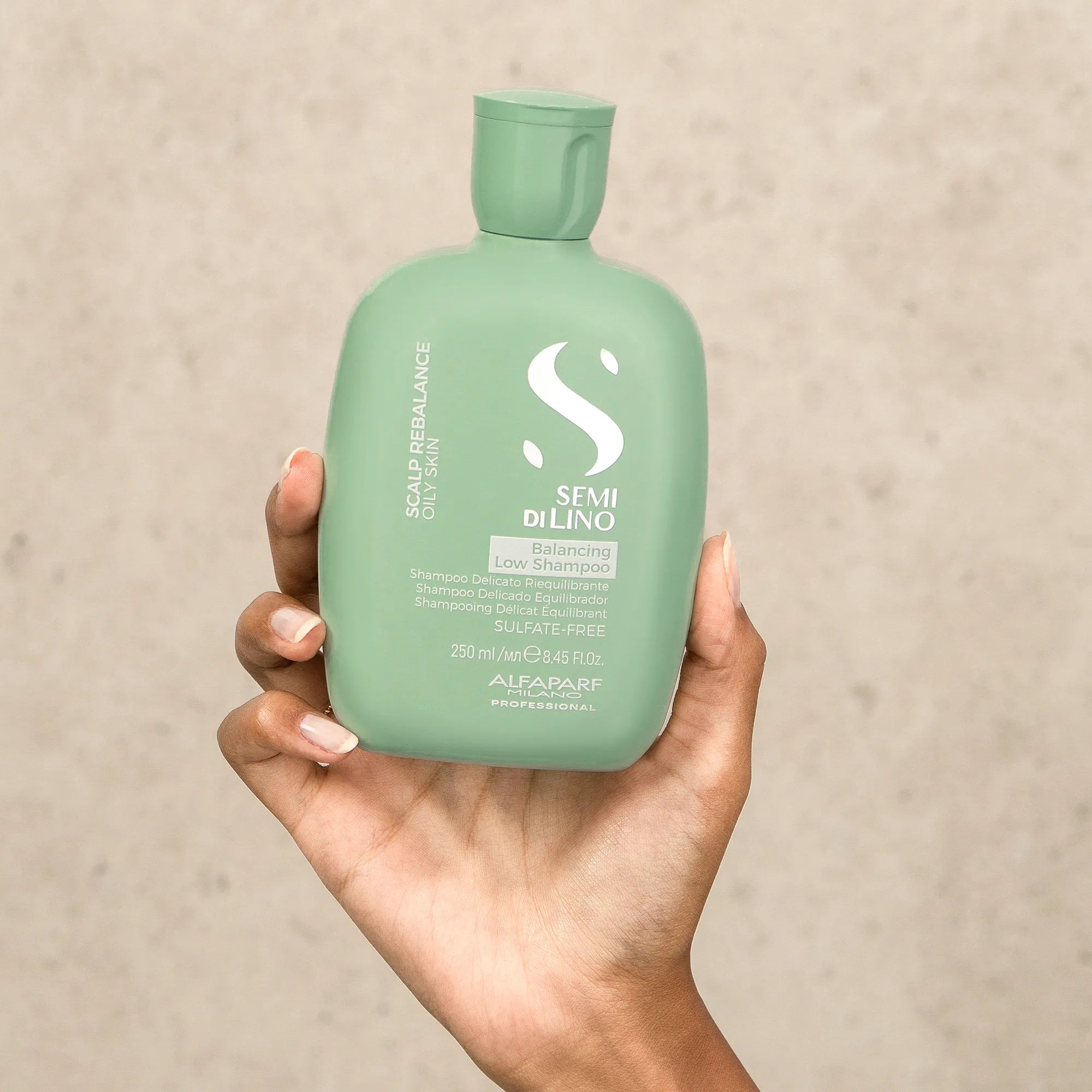 Model holding Alfaparf Milano Semi Di Lino Scalp Balancing Low Shampoo