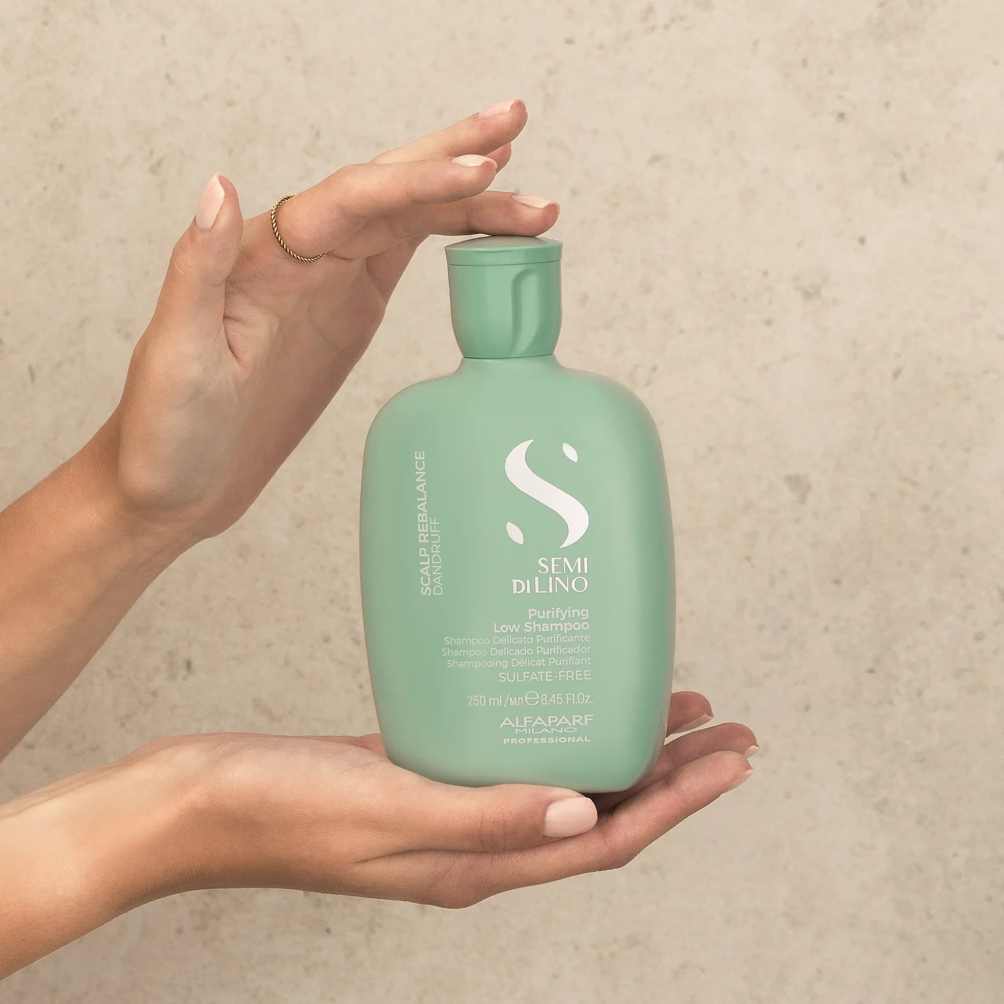Model holding Alfaparf Milano Semi Di Lino Scalp Purifying Low Shampoo
