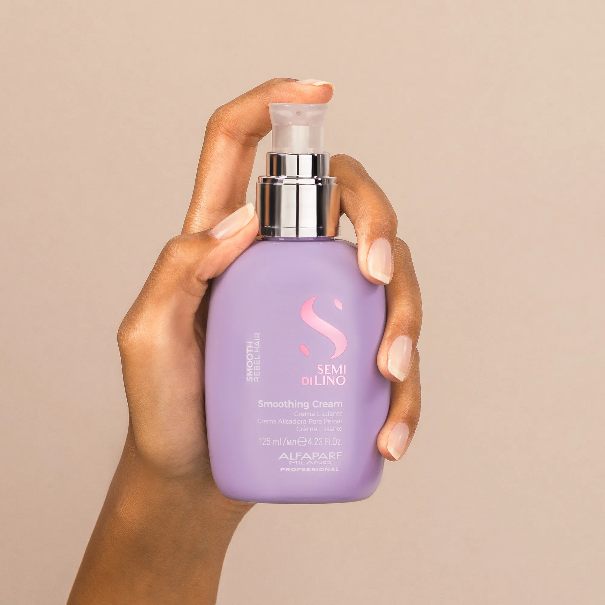Model holding Alfaparf Milano Semi Di Lino Smooth Smoothing Cream 