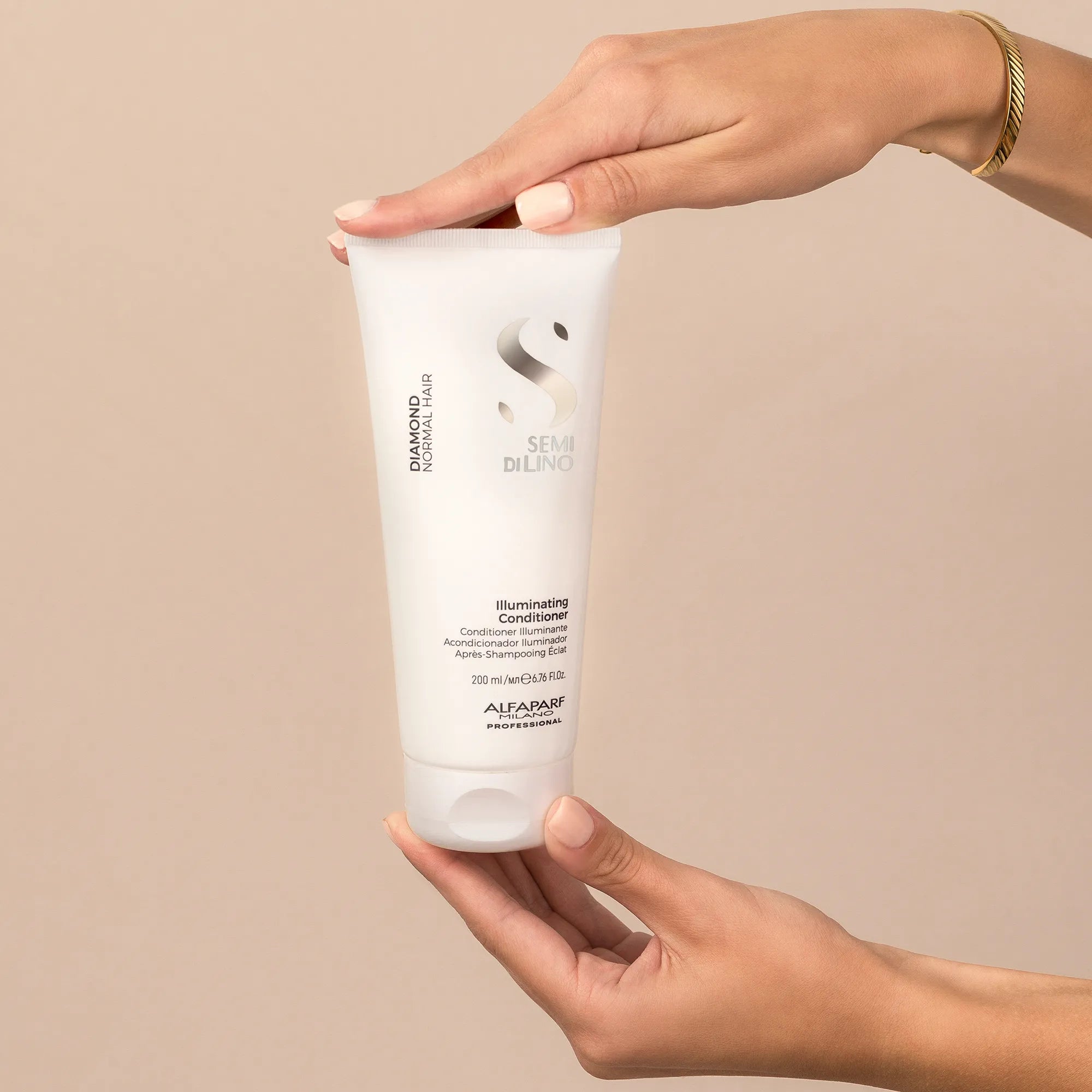 Model holding Alfaparf Milano Semi Di Lino Diamond Illuminating Conditioner 200ml

