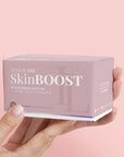 Model holding Instalash SkinBOOST – Dietary Supplement for Skin, Hair, Eyelashes & Nails 60 capsules, packaging