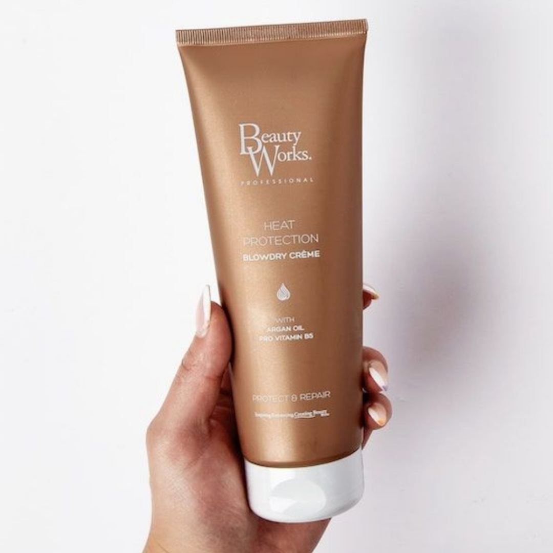 Model holding Beauty Works Blowdry Crème 