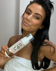 Model holding COCO TAN Self Tanning Mousse