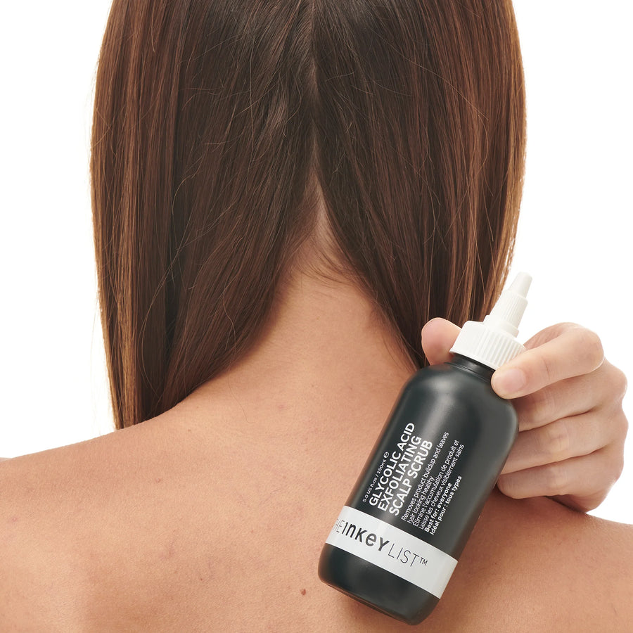 Model holding The Inkey List Gylcolic Scalp Treatment 150ml