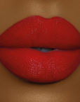 Model wearing DOLL BEAUTY Doll Lipstick - She's Well Red