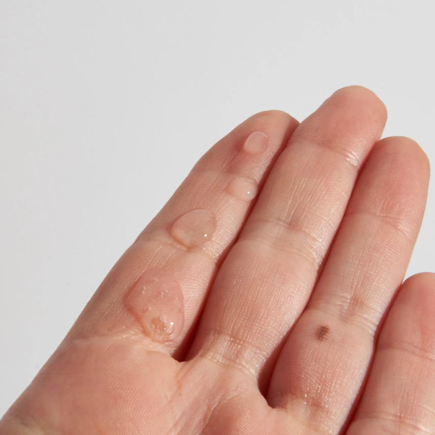 Swatch of The INKEY List Vitamin C Brightening Hair Treatment on model's hand