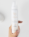 Model holding Beauty Works X Molly Mae Leave-In Vanilla Mousse Conditioner 100ml