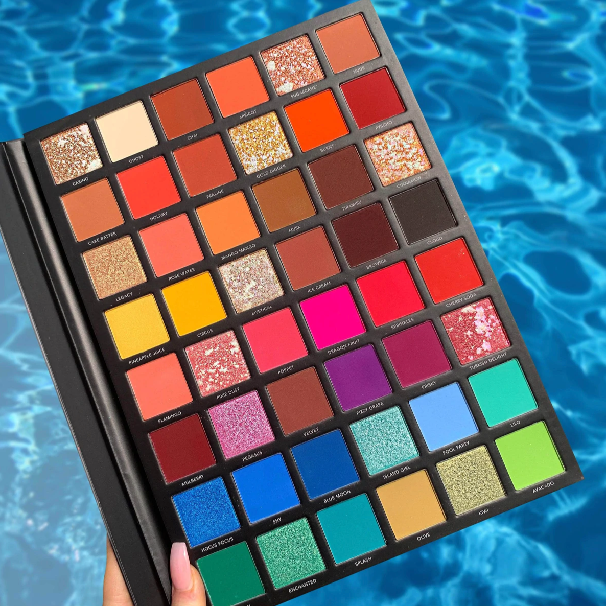 Model holding LaRoc PRO The Artistry Palette by the pool