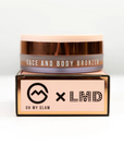 Oh My Glam Fabb Face And Body Bronzer With LMD, sitting on top of packaging