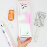 Model holds Beauty Works Styling Heroes Gift Set